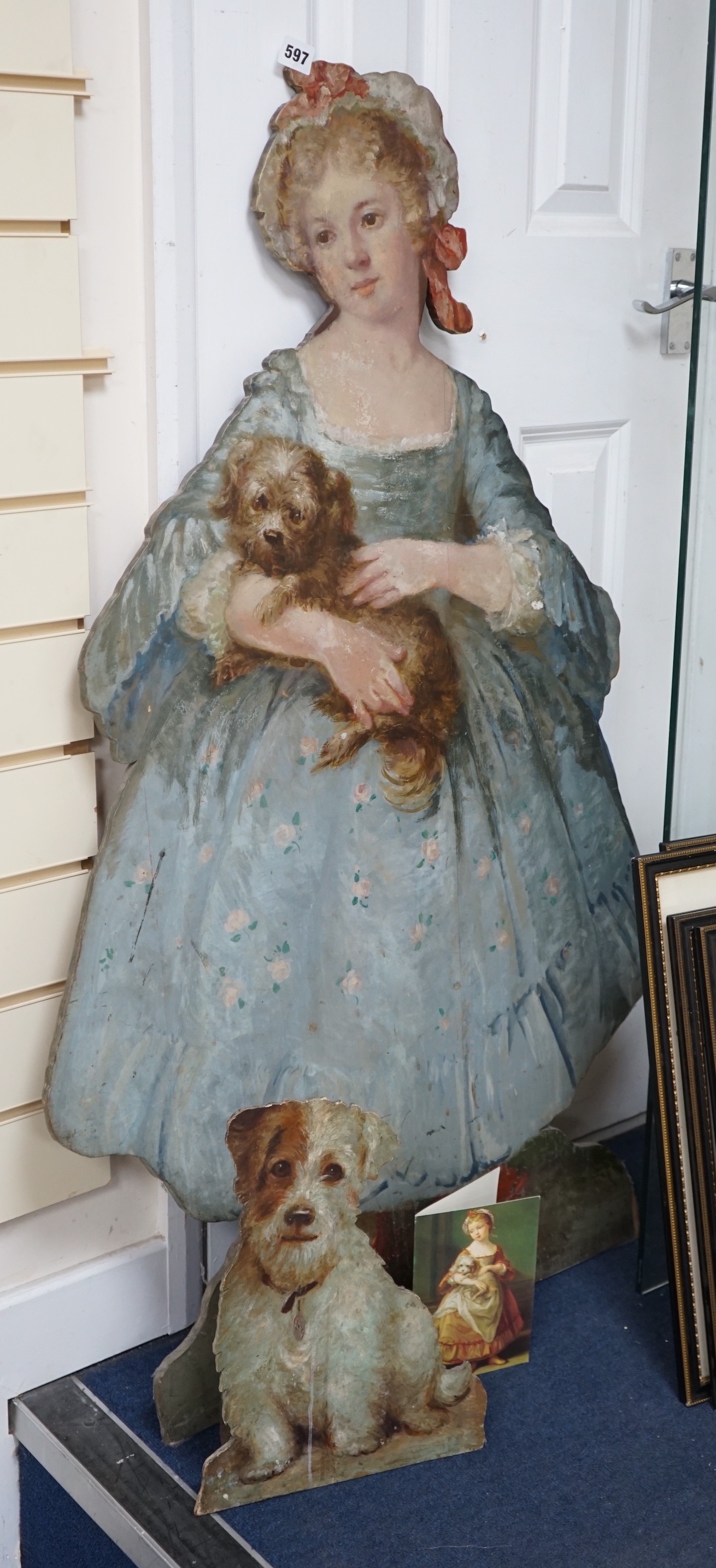 Two painted wood dummy boards, early 20th century, standing figure of a young girl holding a dog, in imitation of Pompeo Batoni (1708-1787), portrait of Countess Stanhope, 112cm tall, together with a smaller wood standin